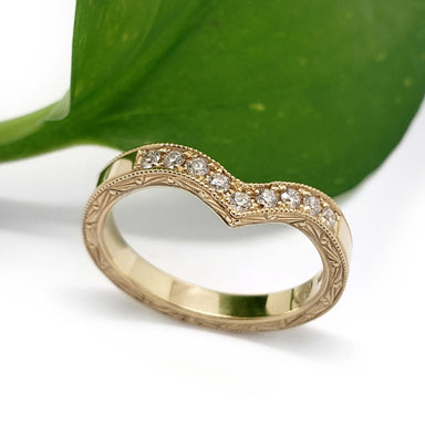 Vintage-inspired yellow gold chevron wedding ring with pave diamonds and hand engraving