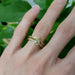 Vintage-inspired yellow gold lab diamond engagement ring stacked with engraved band