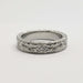 Vintage-style 14kt white gold wedding band with engraved floral pattern and diamonds