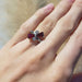 Vintage 10kt white gold cocktail ring with red glass and cubic zirconia shown on hand