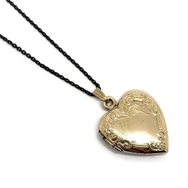 Vintage 14kt yellow gold heart locket pendant with ornate engraving on a black chain