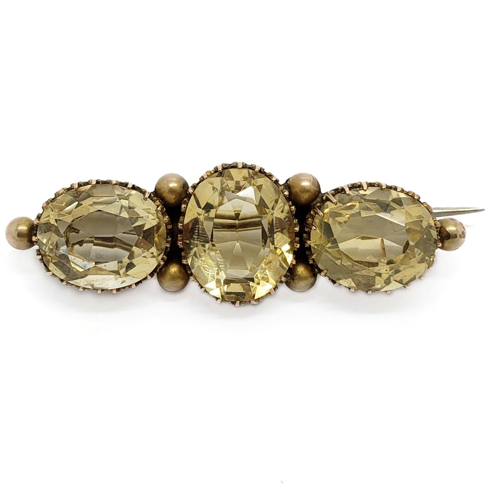 Vintage brooch with three oval faceted citrine gemstones set in yellow gold
