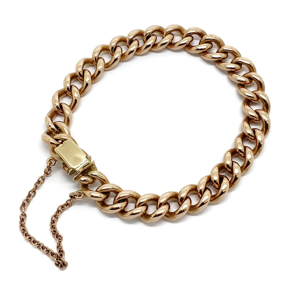 Vintage curb link bracelet in 14K rose gold with a squared clasp and safety chain