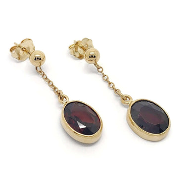 Pair of vintage garnet dangle earrings in 14kt yellow gold with oval red gemstones