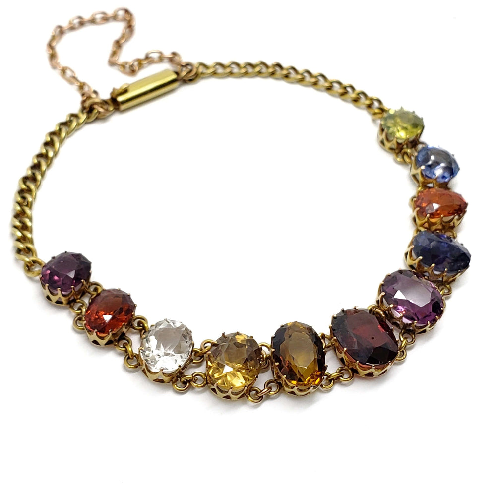 Vintage harlequin bracelet in 14kt yellow gold with assorted coloured gemstones, laid flat