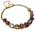 Vintage harlequin bracelet in 14kt yellow gold with assorted coloured gemstones, laid flat