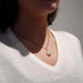 Vintage opal bezel pendant in 14kt yellow gold worn on a black chain