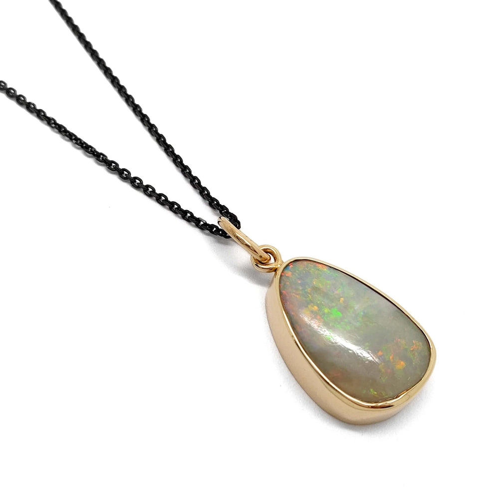 Vintage opal pendant in 14kt yellow gold bezel setting on black chain