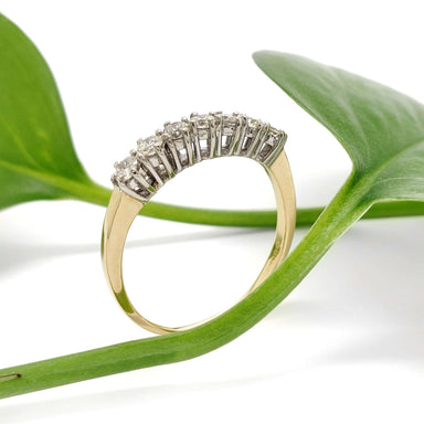 Vintage seven-stone diamond ring in yellow and white gold with diamonds, side view with leaf