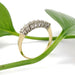 Vintage seven-stone diamond ring in yellow and white gold with diamonds, side view with leaf