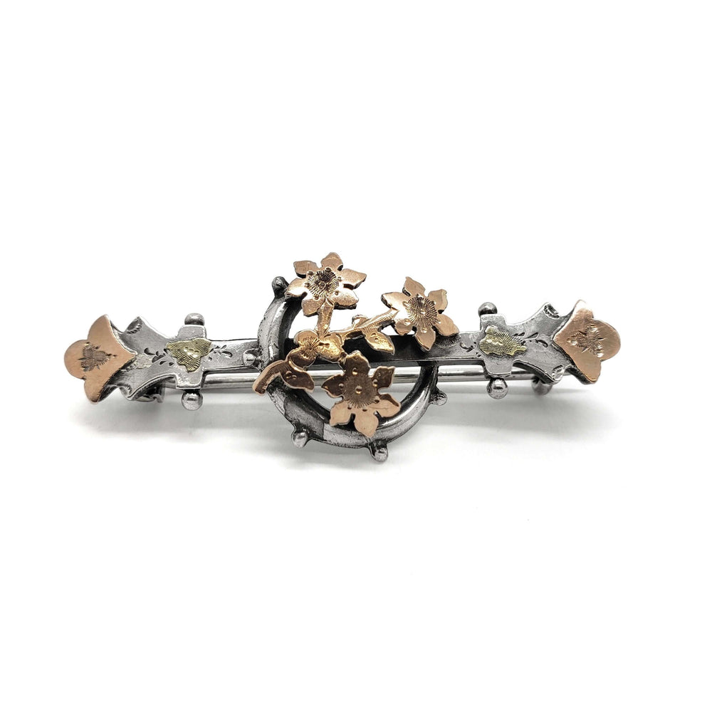 Front view of vintage silver and rose gold pin with crescent moon and floral motif