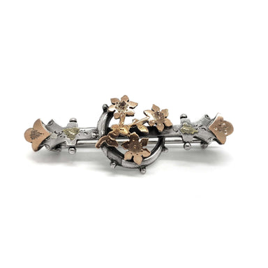 Front view of vintage silver and rose gold pin with crescent moon and floral motif