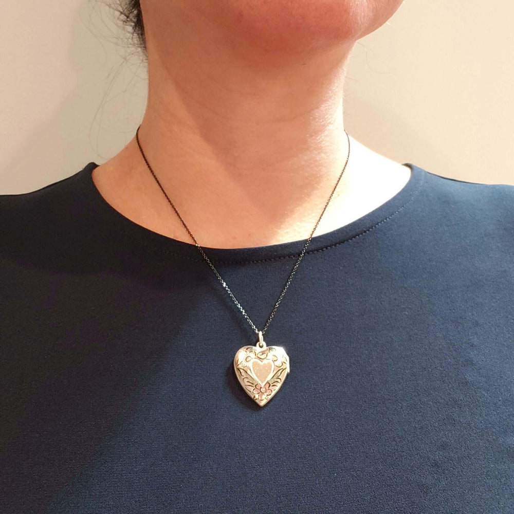Vintage sterling silver heart locket necklace worn on a model