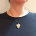 Vintage sterling silver heart locket necklace worn on a model