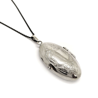 Vintage sterling silver narrow oval locket with floral engraving on a chain