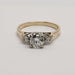 Vintage three-stone diamond engagement ring with central and side diamonds, front view