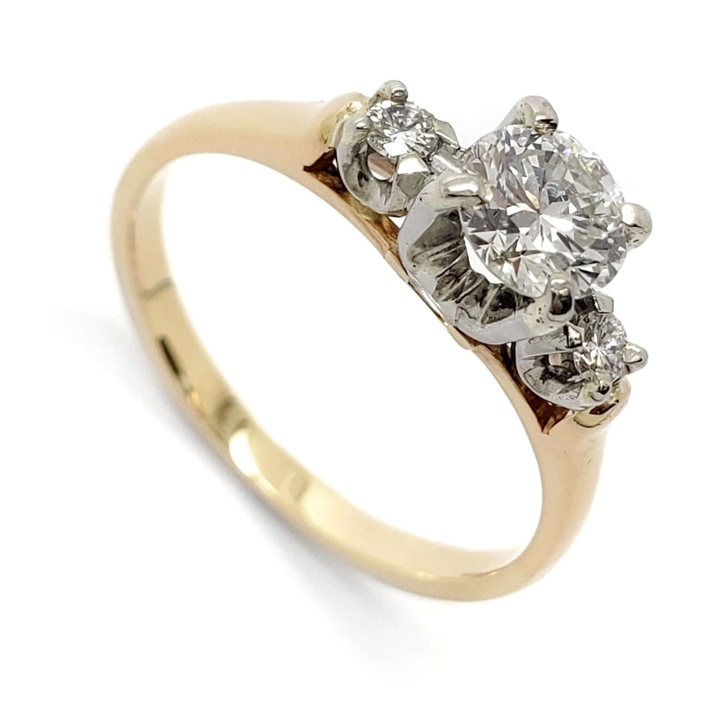 Vintage three-stone diamond ring in 14kt yellow and white gold with round diamonds, angled view