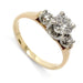 Vintage three-stone diamond ring in 14kt yellow and white gold with round diamonds, angled view