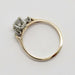 Vintage three-stone diamond ring showing side profile and basket setting, yellow gold band