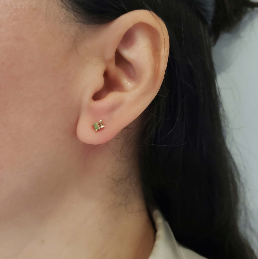 Watermelon tourmaline baguette stud earring in 14kt yellow gold worn on ear