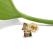 Watermelon tourmaline baguette studs in 14kt yellow gold with a green leaf accent
