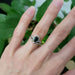 White gold Australian sapphire and diamond ring stacked with another ring, worn on a hand