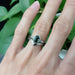White gold Australian sapphire and diamond ring paired with two stacking bands, worn on a hand