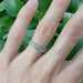 White gold leaf diamond wedding ring worn on hand, close-up