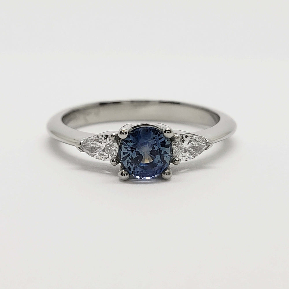 Front view of 14kt white gold ring with blue Montana sapphire and pear cut lab diamonds