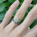 White gold three-stone lab diamond engagement ring stacked with a leaf-inspired band