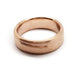 Wide 14kt rose gold wedding band with brushed surface and subtle carved wave