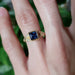 Wren engagement ring with blue sapphire and diamonds worn on hand