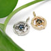 Yellow gold and white gold circle vine sapphire pendants displayed with a green leaf.