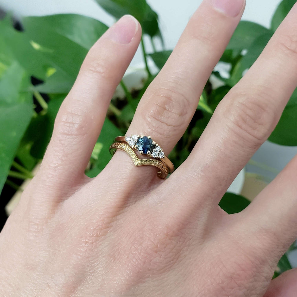 Yellow gold chevron wedding ring stacked with sapphire and diamond engagement ring