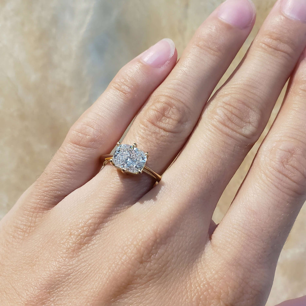 Cushion cut lab diamond engagement ring in yellow gold shown on hand