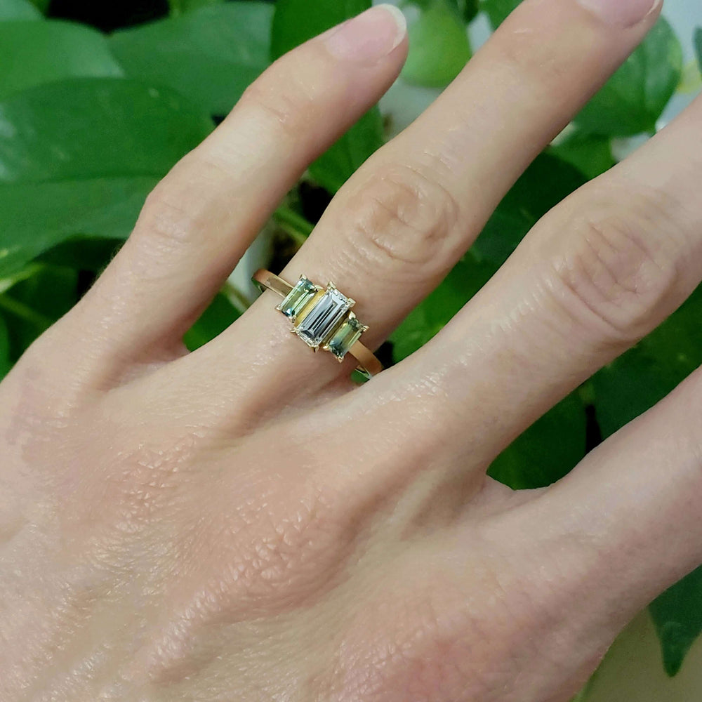 14kt yellow gold ring with diamond and sapphires shown on a hand