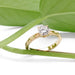 Yellow gold lab diamond engagement ring with leaf details, styled with green leaves