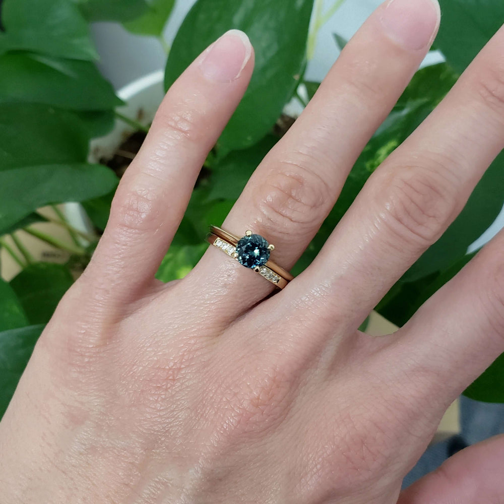 Yellow gold lab diamond wedding ring stacked with teal gemstone engagement ring