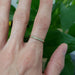 Yellow gold lab diamond wedding ring worn on hand, single band