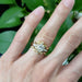 Yellow gold leaf diamond ring stacked with multiple diamond rings on finger