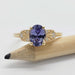 14kt yellow gold sapphire and diamond ring displayed on a pencil
