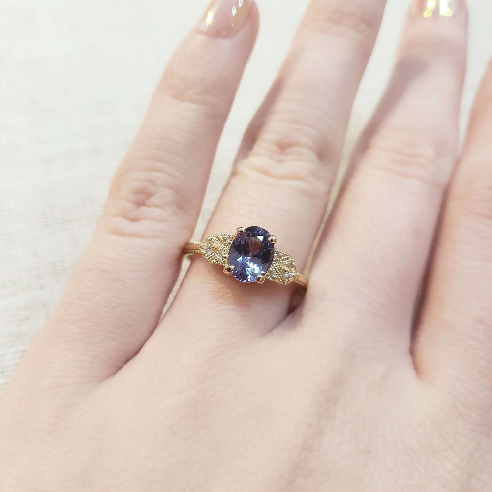 14kt yellow gold sapphire and diamond engagement ring shown on a hand