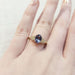 14kt yellow gold sapphire and diamond engagement ring shown on a hand