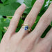 Sapphire and diamond engagement ring in yellow gold stacked with chevron band on hand