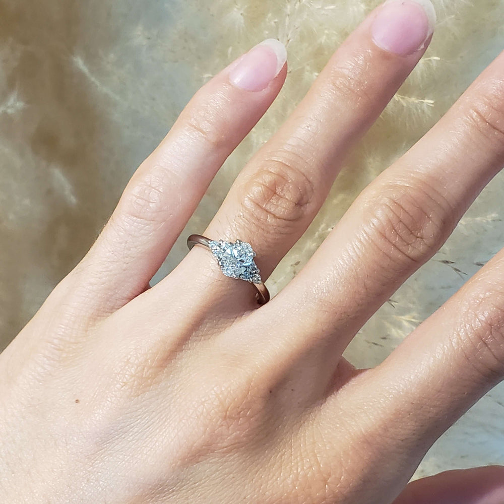 Zira 14kt white gold oval lab diamond engagement ring worn on a hand
