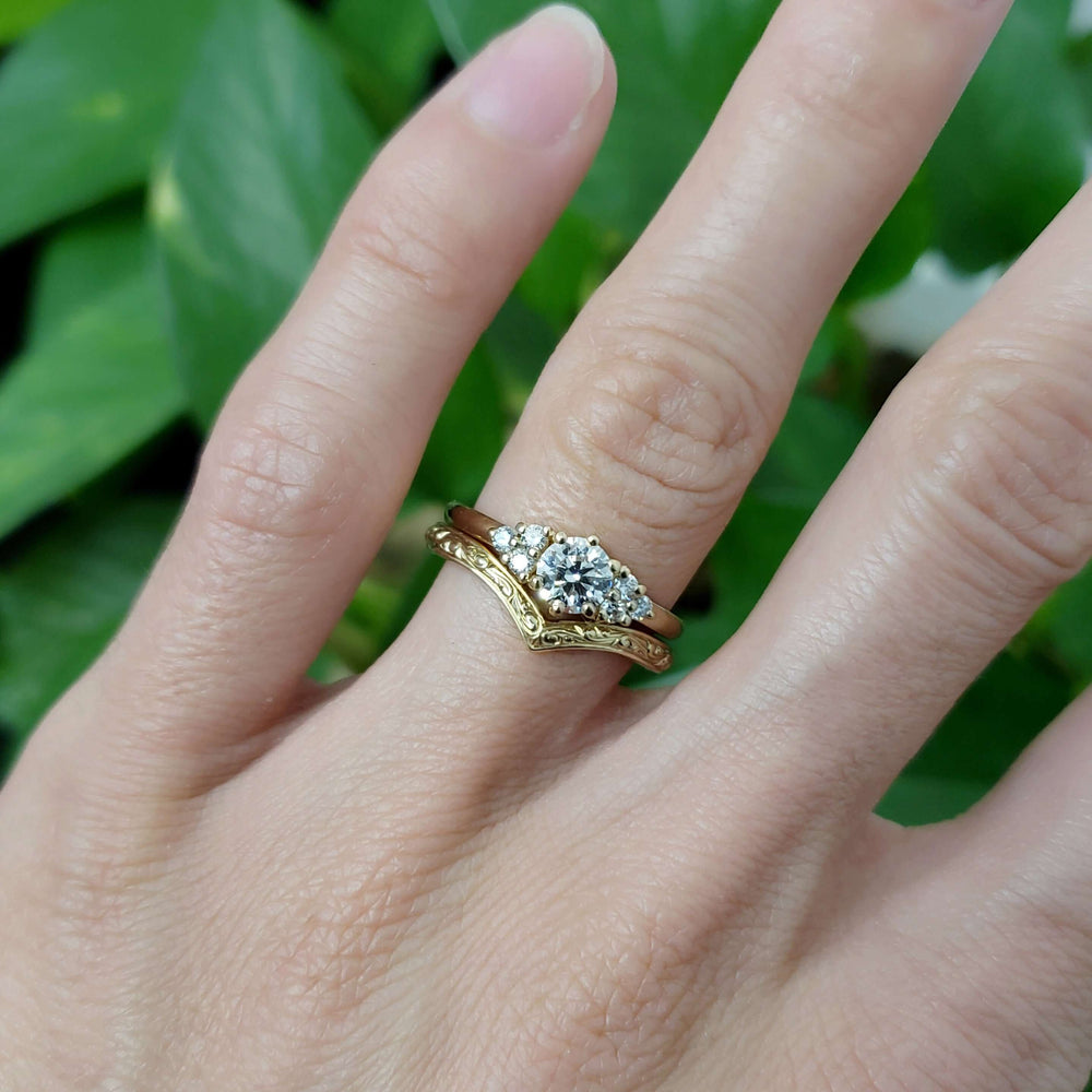 Zira Yellow engagement ring in yellow gold paired with engraved band, shown on hand
