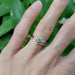 Zira Yellow engagement ring in yellow gold paired with engraved band, shown on hand