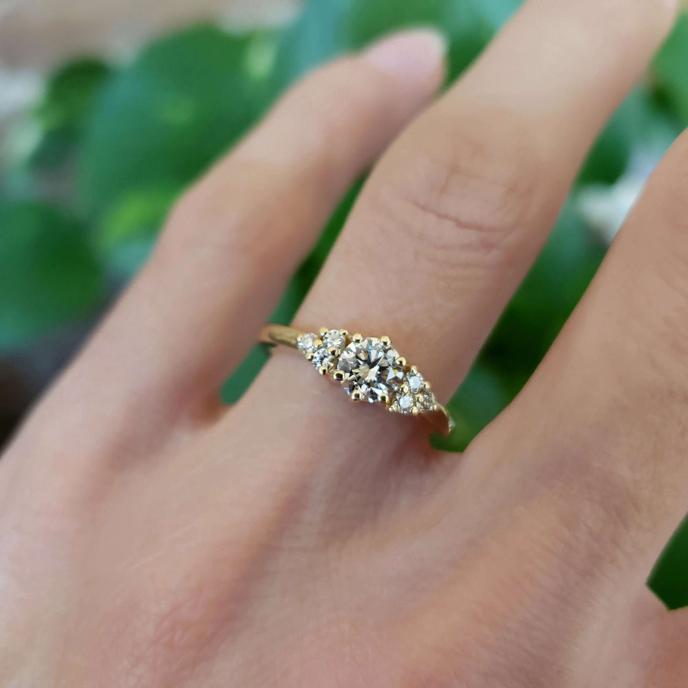 Zira Yellow lab diamond engagement ring in yellow gold shown on hand, close-up