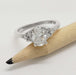 Zira engagement ring with oval lab diamond and side stones, shown next to a pencil