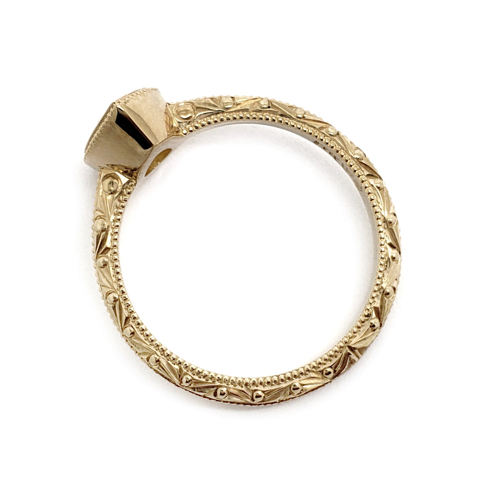 A vintage-style 14kt yellow gold ring with an ornate, engraved band and a large, tapered bezel setting, shown on a plain white background.